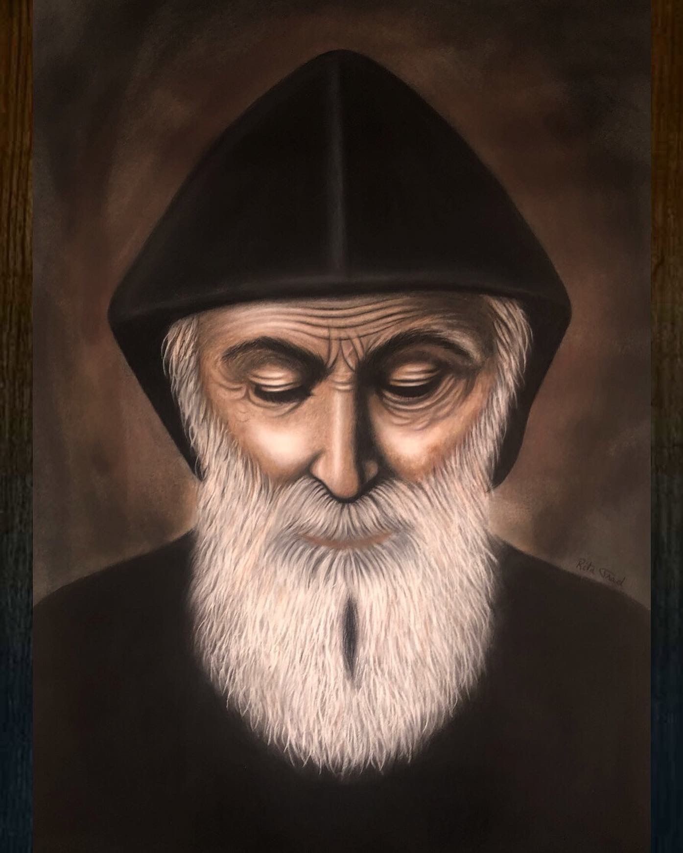 Dark hooded figure with a long white beard against a dark, textured background.